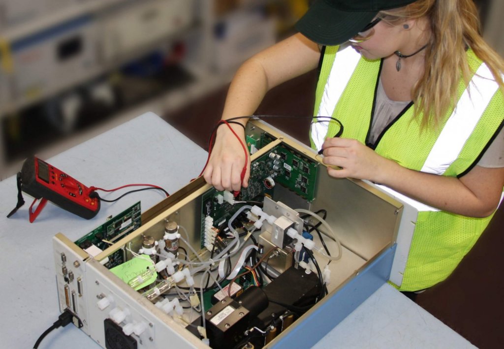 Woman repairing CEMS analyzer